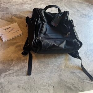 Tumi black laptop bag with luggage tag -zipper flaw
